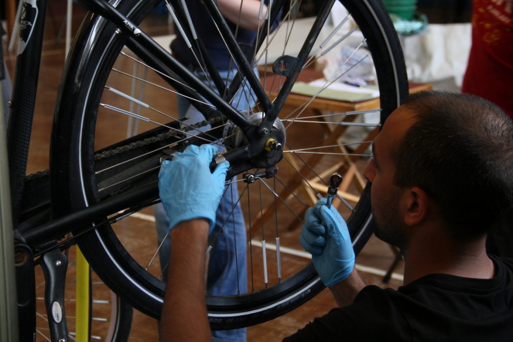 volunteer-fixing-a-bicycle